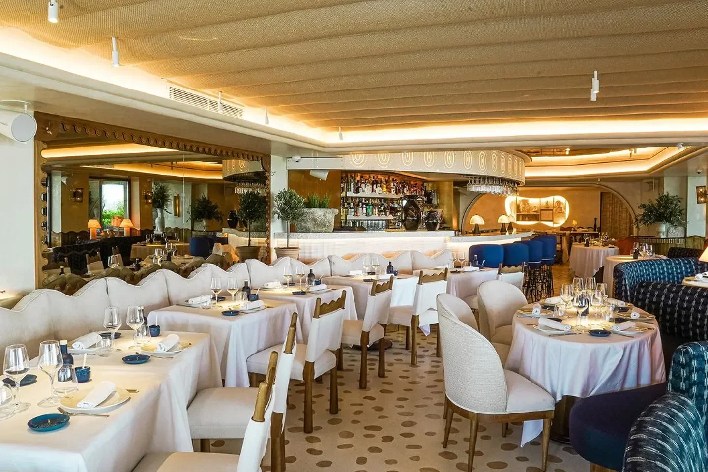 Elegant interior of Anna restaurant in Cannes, with tables set and a stylish bar area.