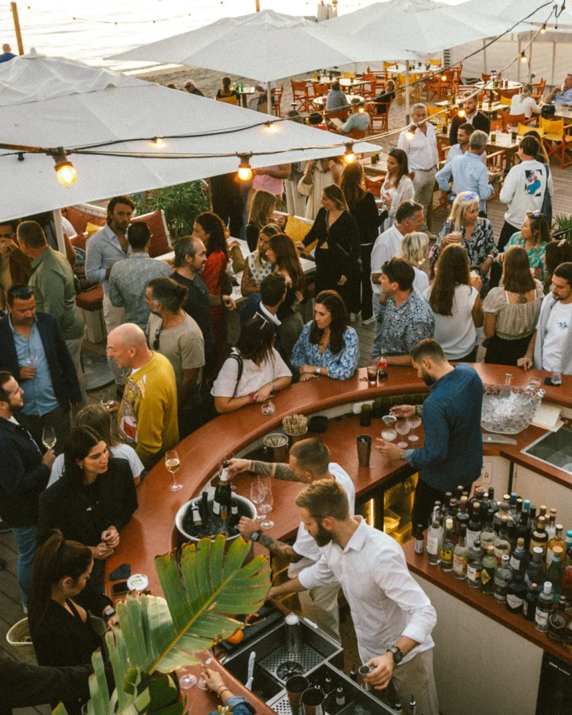 Guests enjoying drinks and the atmosphere at Bijou Plage restaurant in Cannes during daytime