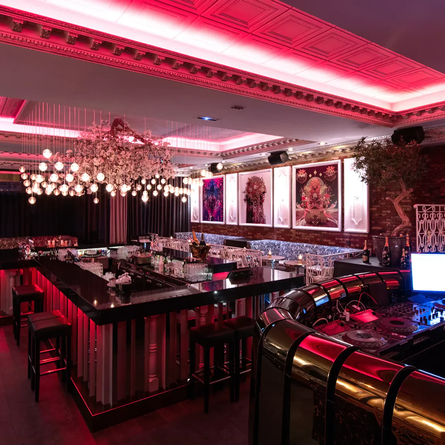 Interior of Chrystie nightclub in Cannes, featuring a stylish bar and red lighting.