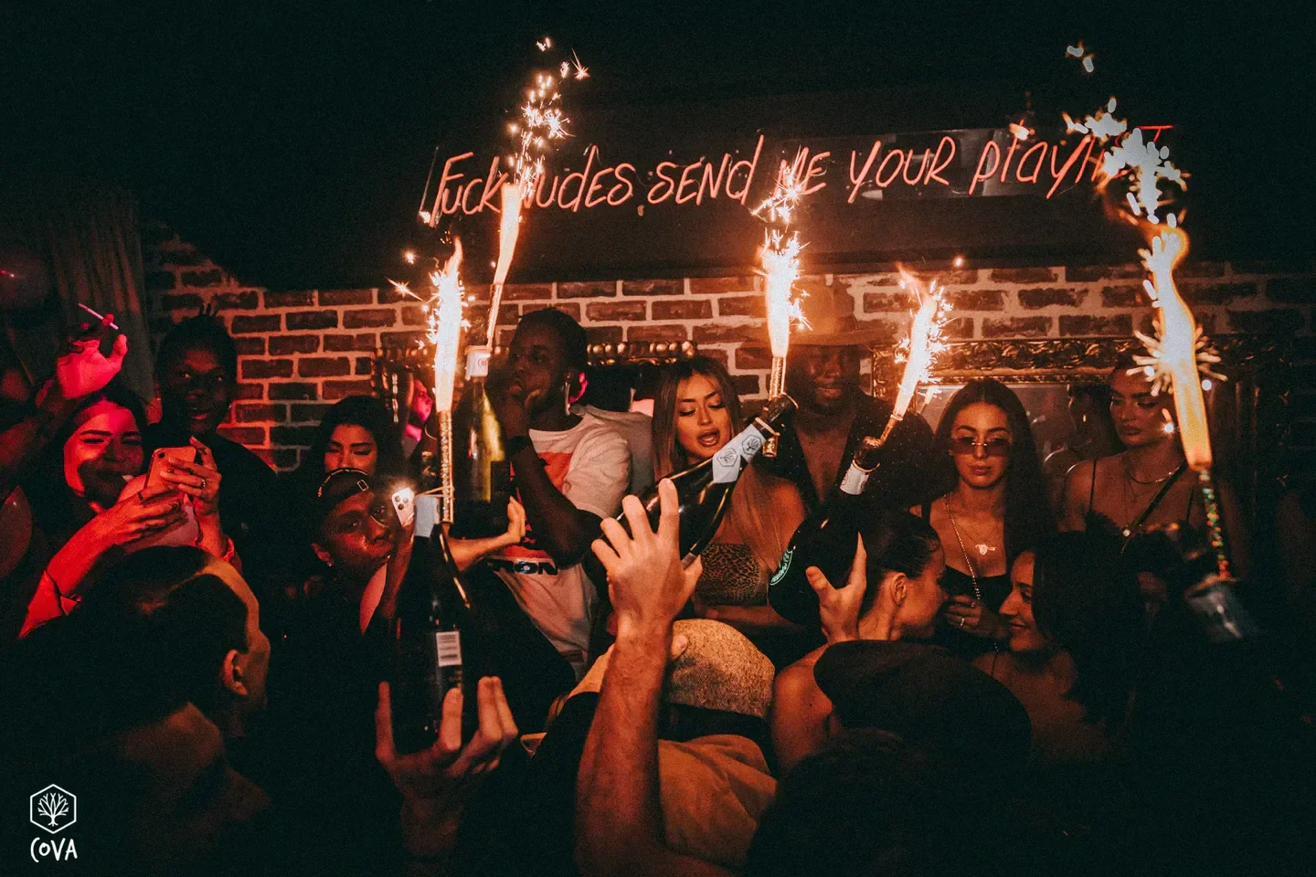 Celebratory atmosphere at Cova nightclub in Cannes, with sparklers and champagne.