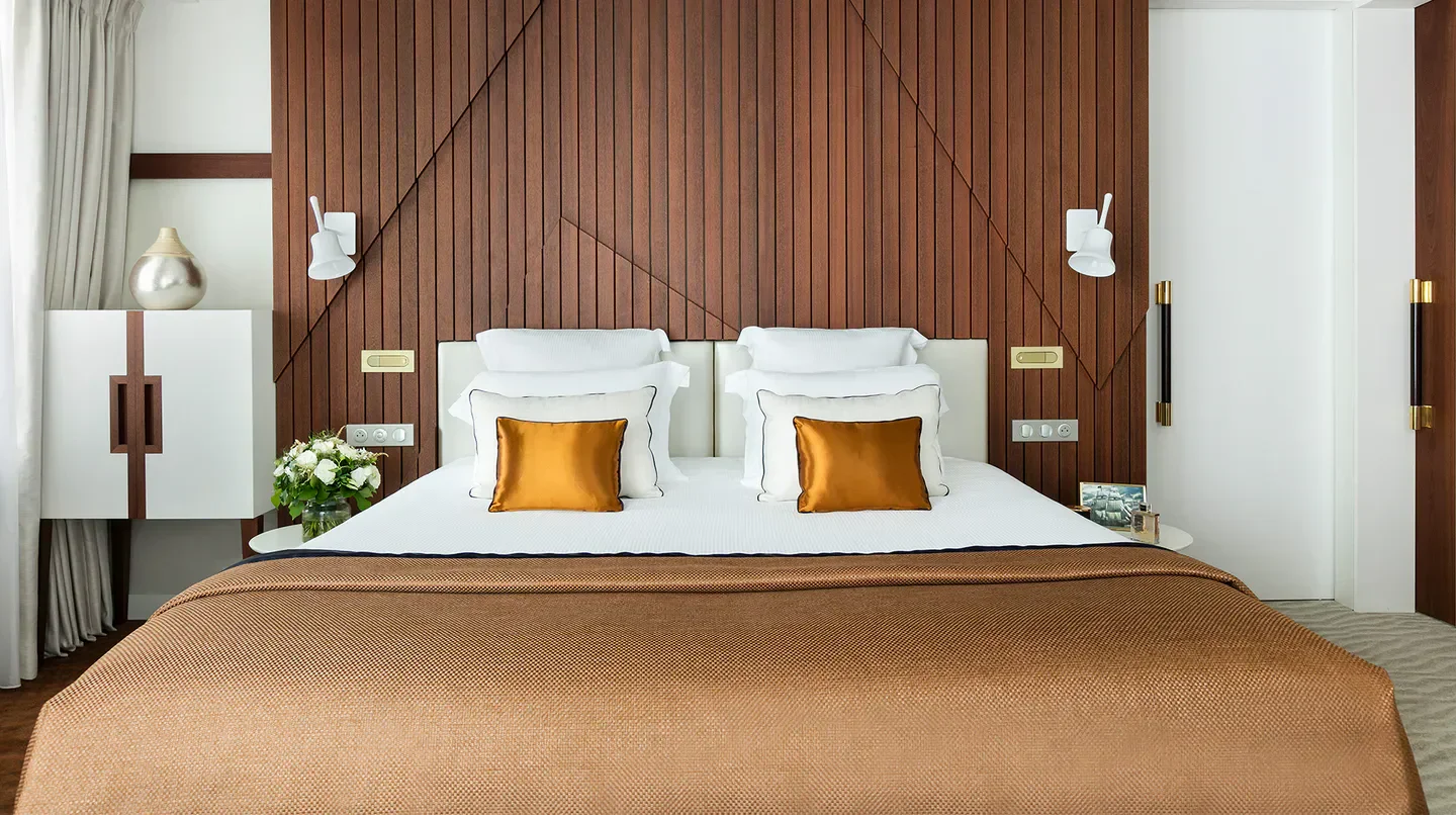 Elegant bedroom at Hôtel Barrière Le Majestic in Cannes with a cozy atmosphere.