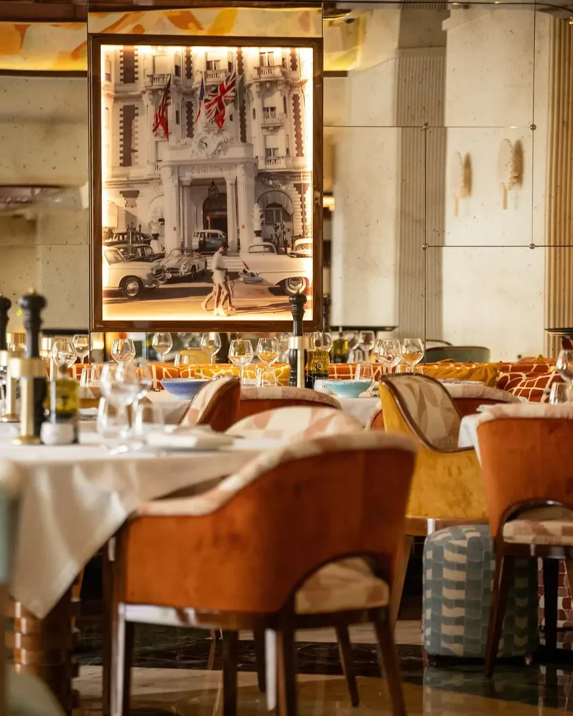 Elegant dining interior at La Mome Plage in Cannes with vintage photo decor