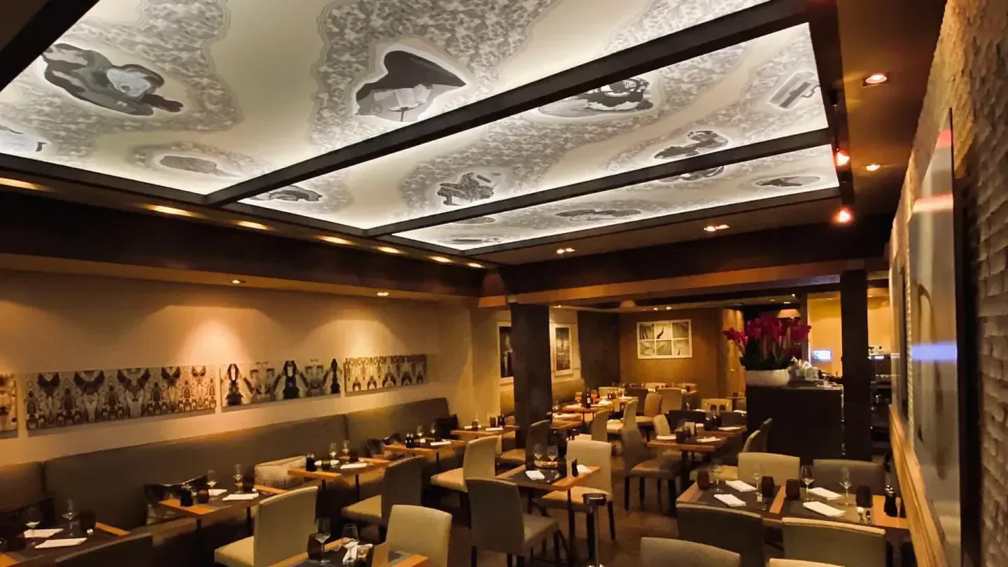 Elegant dining room at L'Affable restaurant in Cannes, with unique ceiling design