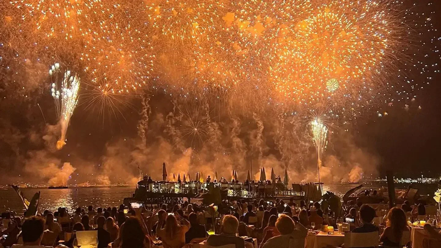 Spectacular fireworks over Miramar Plage in Cannes during a lively beach club event