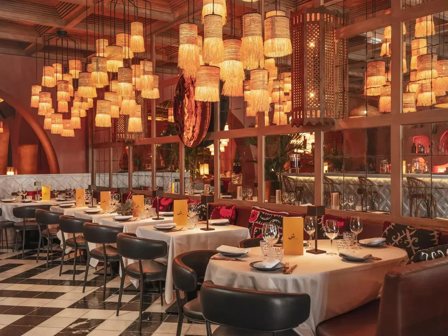 Elegant interior of Salama restaurant in Cannes, featuring stylish lighting and dining tables.