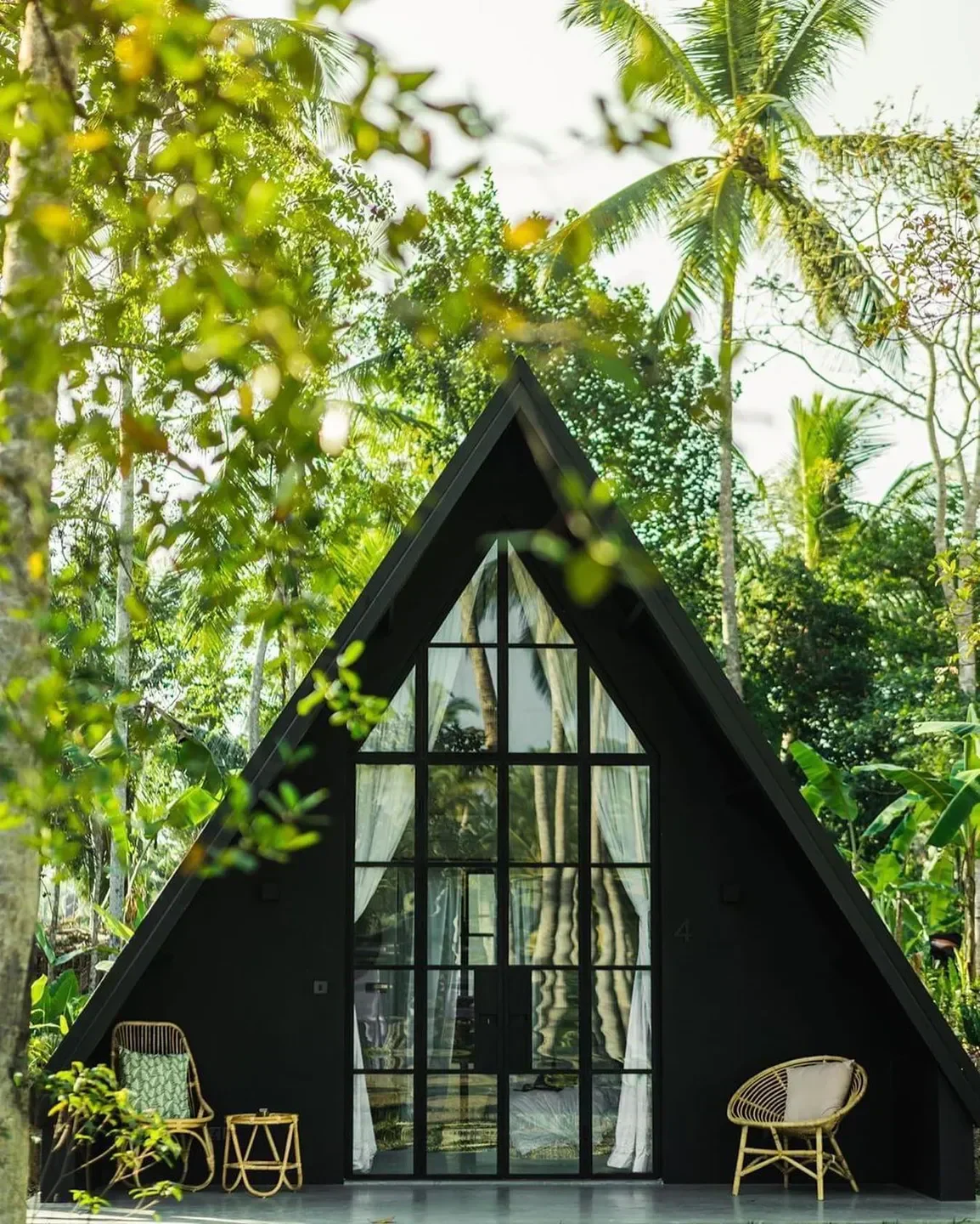 Exterior of Vegaluna restaurant in Cannes, with a unique triangular building and tropical vibe.