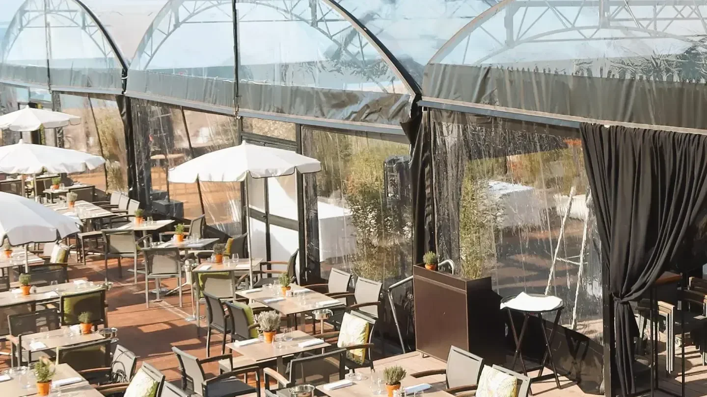 Outdoor dining area at Vegaluna beach club in Cannes with transparent roof
